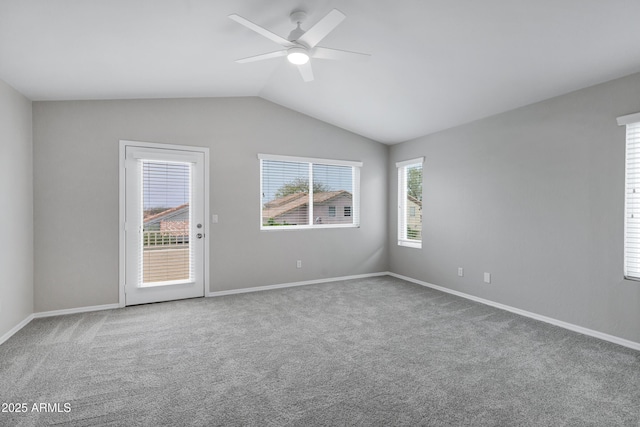 carpeted spare room with lofted ceiling, baseboards, and ceiling fan