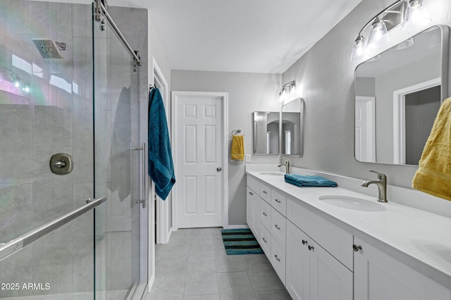 full bath with a sink, a stall shower, and double vanity