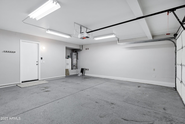 garage featuring gas water heater, a garage door opener, and baseboards