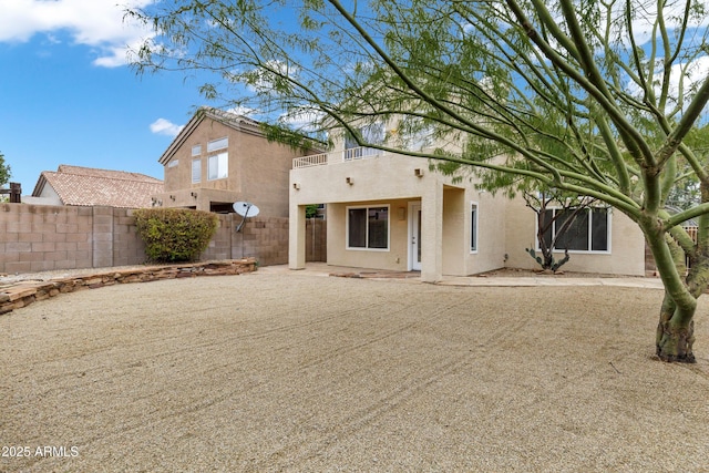 back of house with a patio, fence, and stucco siding