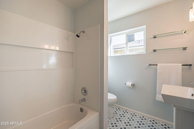 full bath featuring shower / washtub combination, toilet, and baseboards