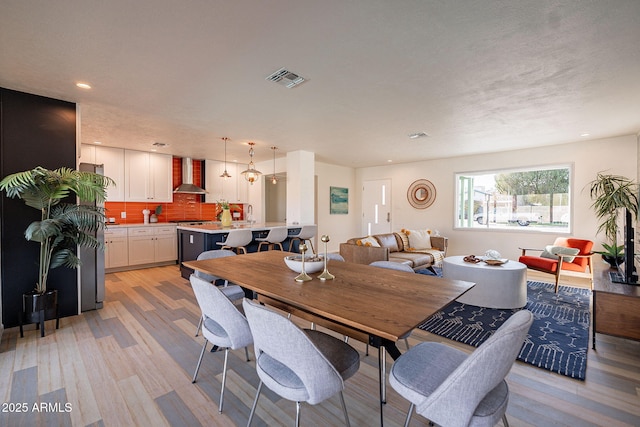 dining area featuring light wood-type flooring, visible vents, and recessed lighting