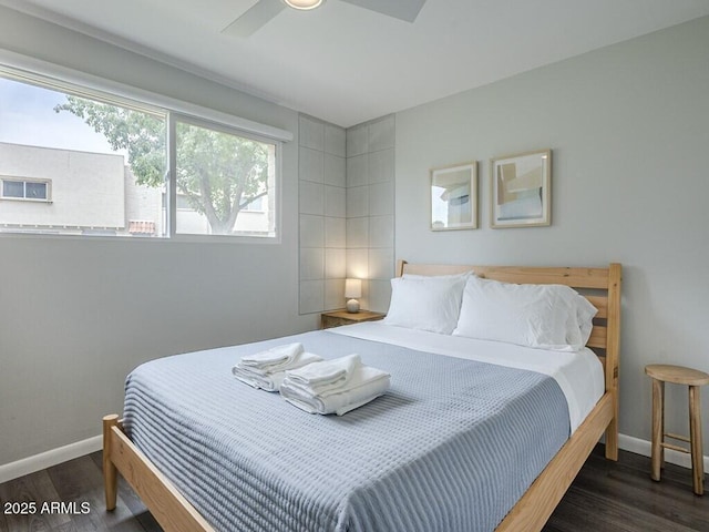 bedroom with wood finished floors, baseboards, and a ceiling fan