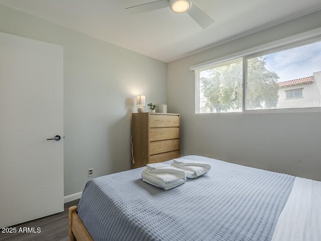 bedroom featuring wood finished floors, ceiling fan, and baseboards