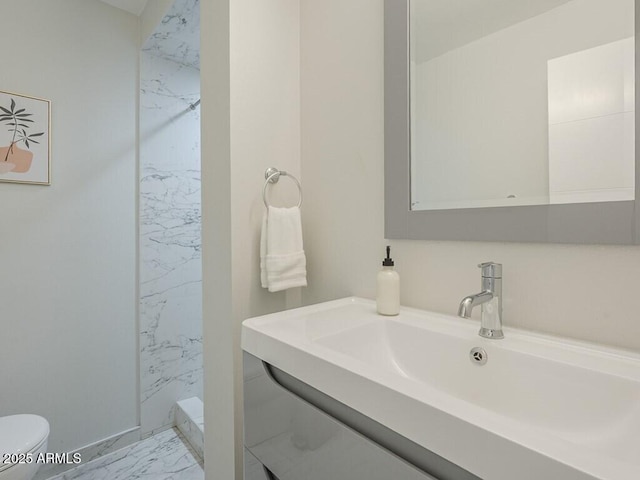full bathroom featuring marble look tiles, toilet, a shower, and vanity