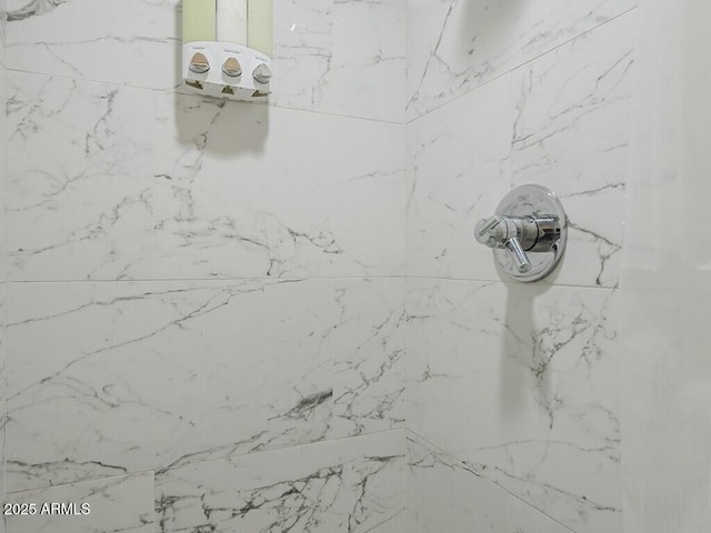 bathroom view of a marble finish shower
