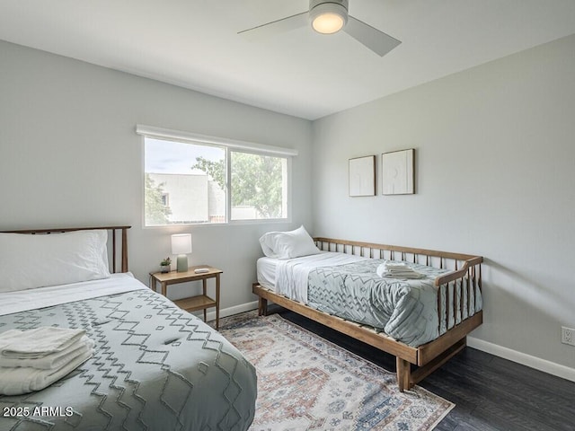 bedroom with baseboards, wood finished floors, and ceiling fan