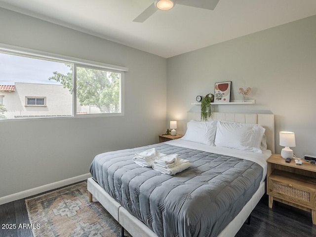 bedroom featuring wood finished floors, baseboards, and a ceiling fan