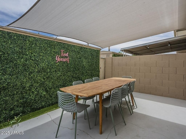 view of patio / terrace featuring outdoor dining area and fence