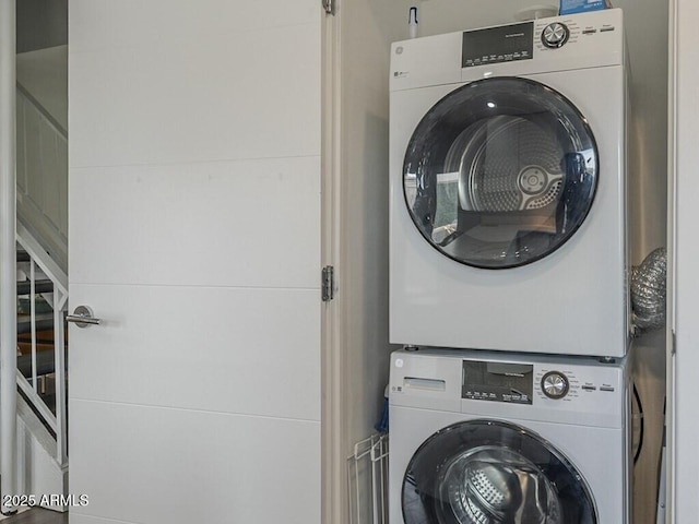 washroom featuring stacked washing machine and dryer