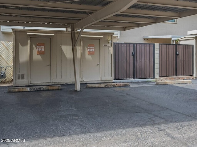 garage with covered parking and a gate