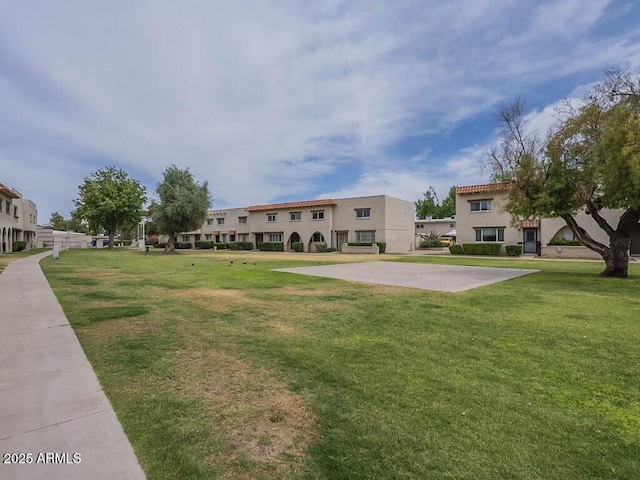 view of community featuring a yard and a residential view