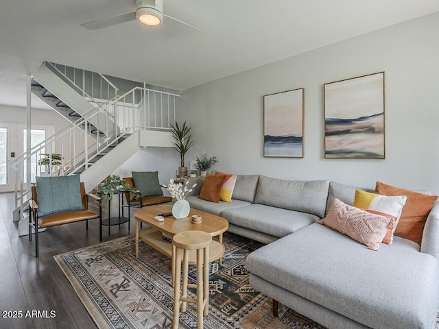 living room featuring wood finished floors, stairway, and ceiling fan