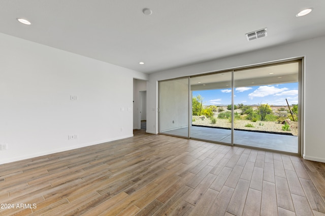 spare room with light wood-type flooring