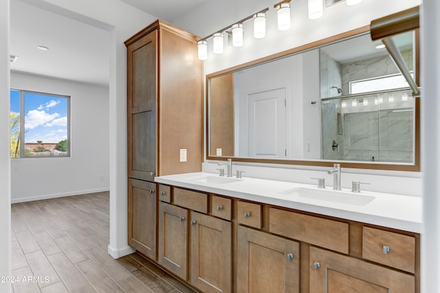 bathroom featuring wood-type flooring, vanity, and a shower with door