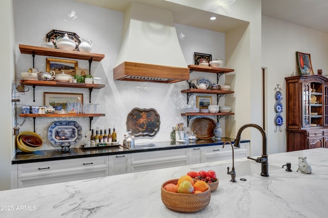 bar with white cabinets, dark stone countertops, black electric stovetop, and custom range hood