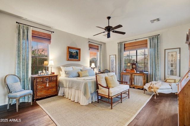 bedroom with ceiling fan and dark hardwood / wood-style flooring