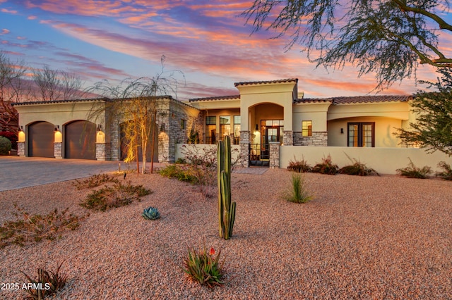 mediterranean / spanish-style home with a garage