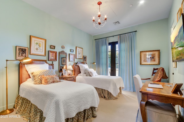 bedroom with french doors and a chandelier