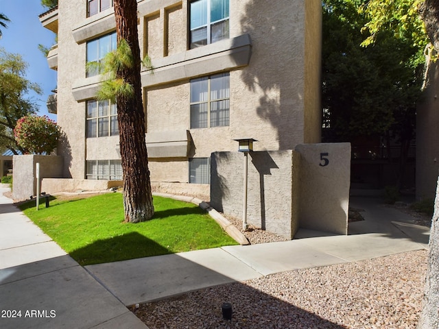 view of side of property with a lawn