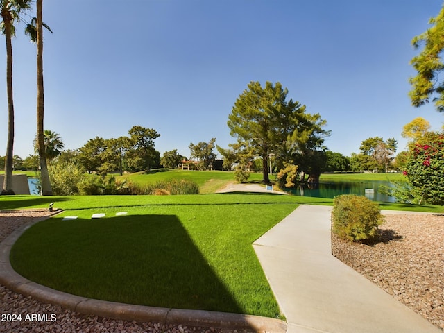 view of home's community with a yard and a water view