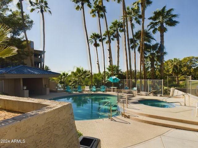 view of pool with a patio and a community hot tub