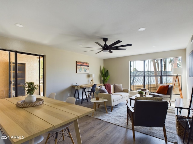 living room featuring wood-type flooring and ceiling fan