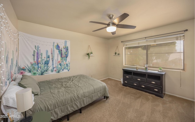carpeted bedroom with baseboards and a ceiling fan