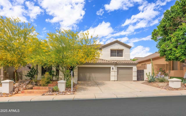 view of front of home featuring a garage, a tile roof, driveway, and stucco siding