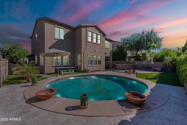 1128 E Phelps St, Gilbert, AZ 85295 - pool at dusk featuring a patio and a fenced backyard