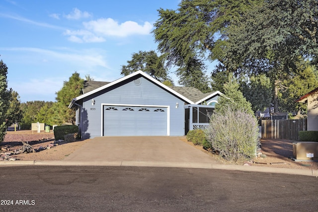 ranch-style home with fence, an attached garage, and driveway