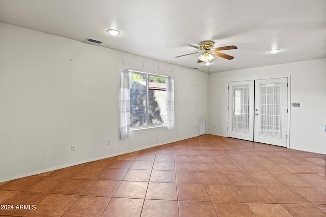 unfurnished room featuring light tile patterned flooring, ceiling fan, and french doors