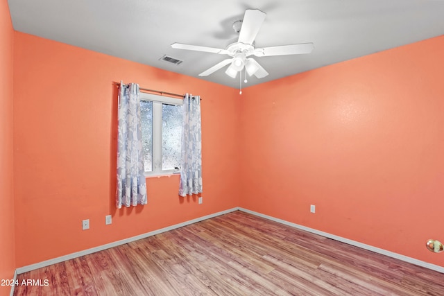 empty room featuring ceiling fan and light hardwood / wood-style flooring