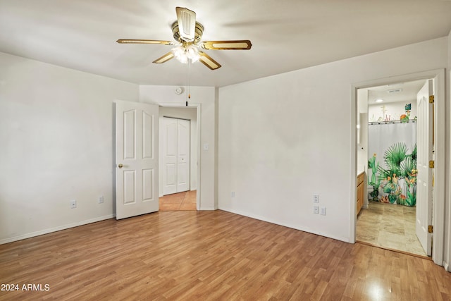 empty room with ceiling fan and light hardwood / wood-style floors