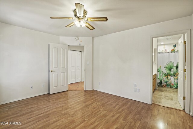 unfurnished bedroom featuring light wood-style floors, a ceiling fan, and baseboards