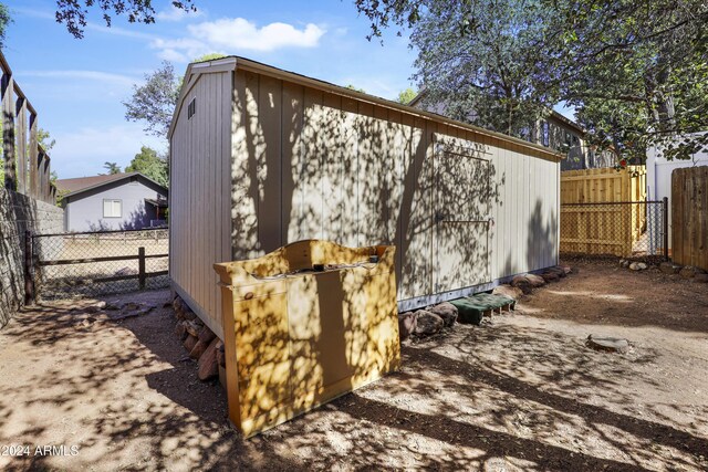 view of shed with a fenced backyard