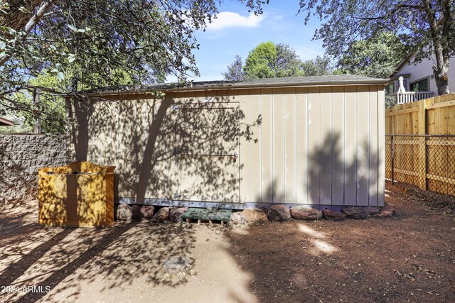 view of shed featuring fence