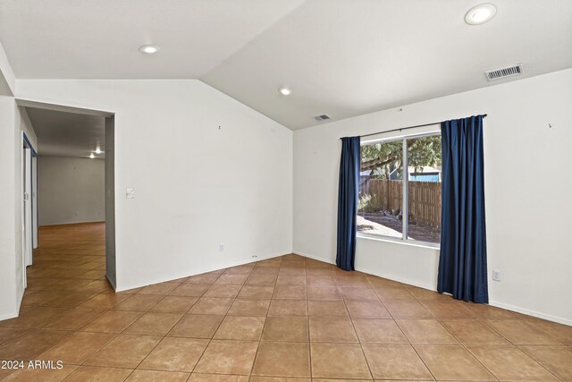 empty room with recessed lighting, visible vents, and lofted ceiling