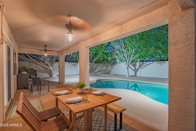 view of swimming pool featuring ceiling fan, a patio area, a fenced backyard, and a fenced in pool