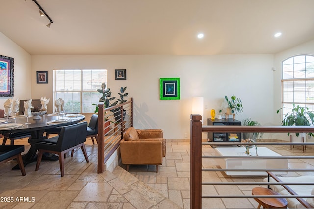 dining space with recessed lighting, stone tile flooring, and track lighting