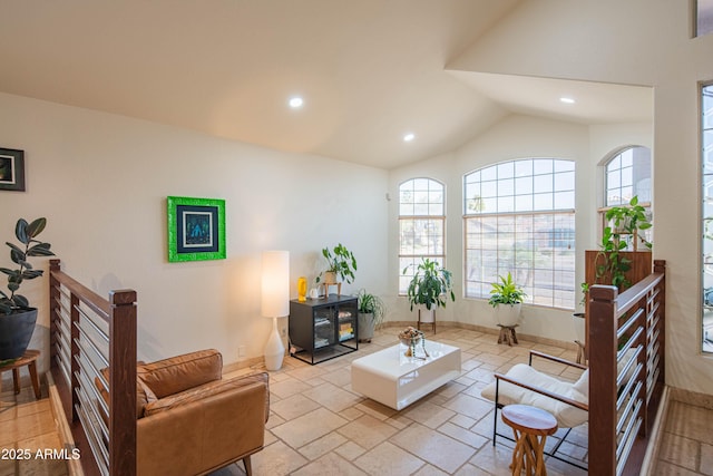 living room featuring lofted ceiling, recessed lighting, baseboards, and a healthy amount of sunlight