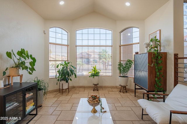 sitting room featuring recessed lighting, stone tile flooring, and baseboards