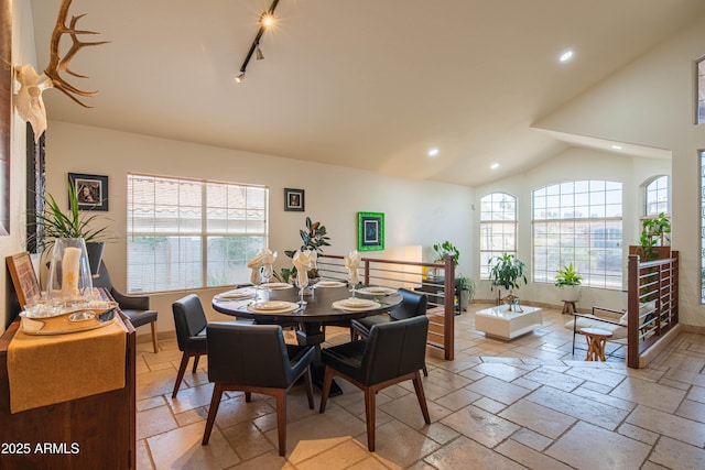 dining room featuring lofted ceiling, recessed lighting, baseboards, and stone tile floors