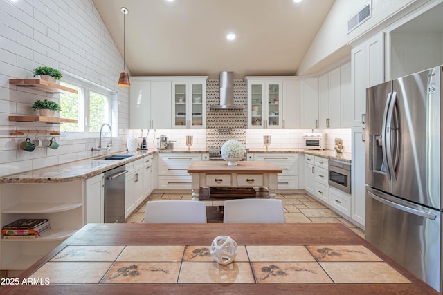 kitchen with stainless steel appliances, open shelves, visible vents, vaulted ceiling, and wall chimney exhaust hood