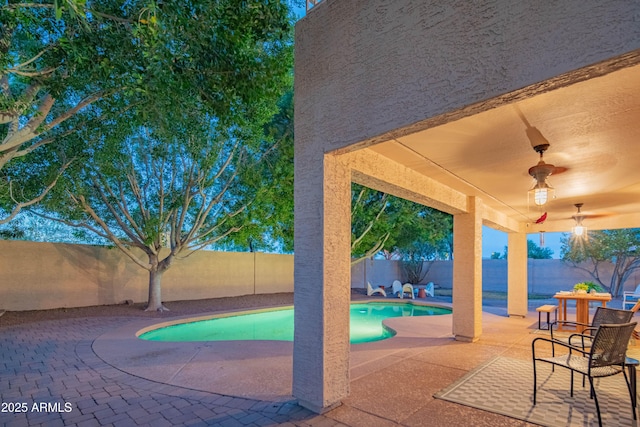 view of pool featuring ceiling fan, a patio, a fenced backyard, and a fenced in pool