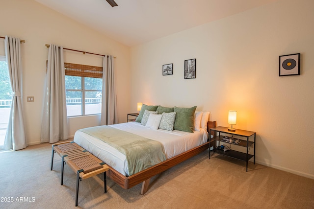 bedroom with multiple windows, vaulted ceiling, and carpet flooring