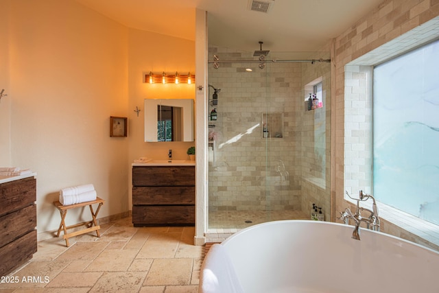 full bathroom featuring a freestanding tub, stone tile floors, vanity, visible vents, and a shower stall