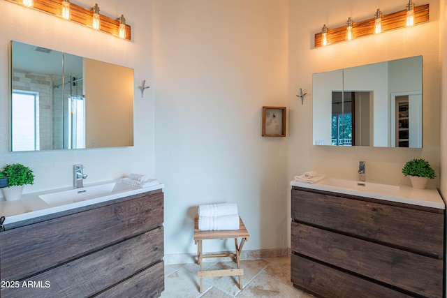 bathroom with two vanities, a sink, a shower with door, and baseboards