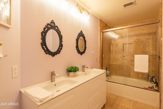 full bathroom featuring stone tile flooring, visible vents, a sink, and bath / shower combo with glass door