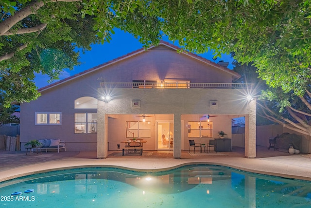 pool with a patio and fence